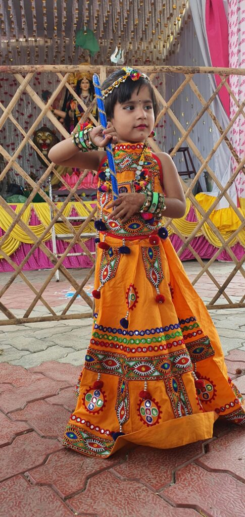 Girl in Ornate Orange Lehenga Standing by Altar